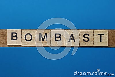 Gray word bombast in small square wooden letters Stock Photo