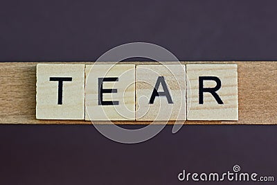 Gray word tear made of wooden square letters Stock Photo