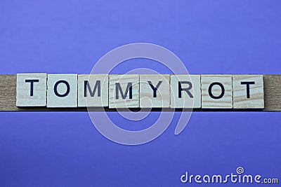 Gray word tommyrot in small square wooden letters Stock Photo
