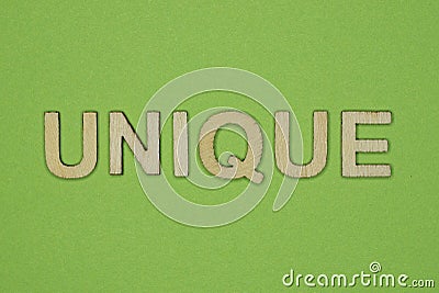 Gray word unique from small wooden letters Stock Photo