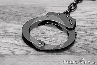 Grayscale 3D render: black locked police handcuffs Stock Photo