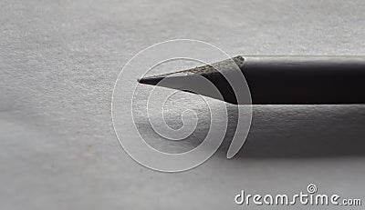 Grayscale image of a sharp pencil on a table with an indistinct shadow, close-up Stock Photo