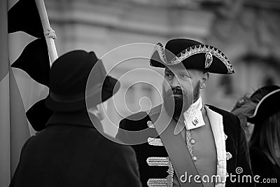 Grayscale of a person dressed in an old uniform during a historical parade in Timisoara, Romania. Editorial Stock Photo