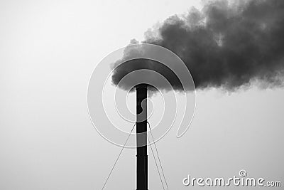 Grayscale shot of a factory emitting black toxic smoke Stock Photo