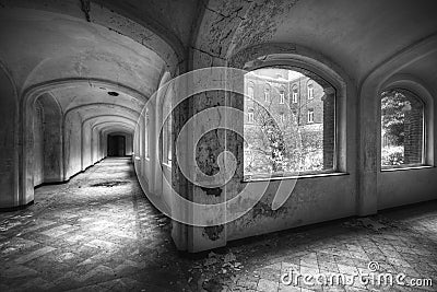 Grayscale shot of the hallways of an old abandoned building in winter Stock Photo