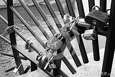 Grayscale shot of the padlocks of love on a metallic fence Editorial Stock Photo