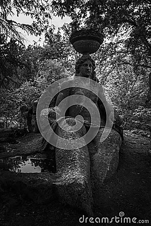 Grayscale shot of the sculpture of the giant Persephone at the famous monster park in Italy Stock Photo