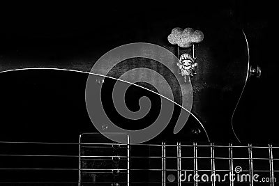 Grayscale shot of wood trim on a Fender Telecaster guitar with a girl in cloud swing Stock Photo