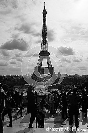 Grayscale vertical shot of the tourists crowd with the Eiffel Tower in background in Paris, France Editorial Stock Photo