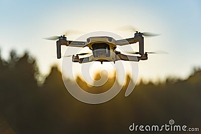 Graz, Austria: 02.01.2020 - Close up shoot of a DJI Quadcopter Drone Mavic mini 249g. Drone flying against sun background Editorial Stock Photo