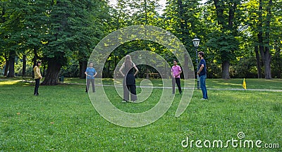 Graz/Austria - June 24, 2019: People doing yoga and sports in the park, in summertime Editorial Stock Photo