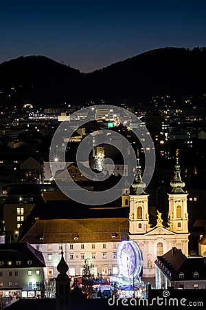 Graz with church Mariahilf and christmas fair with ferris wheel Stock Photo