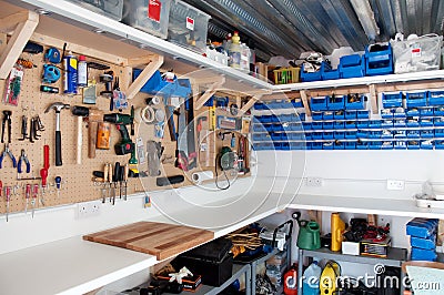 Workshop area in a home garage with organisation of tools and DIY equipment Editorial Stock Photo