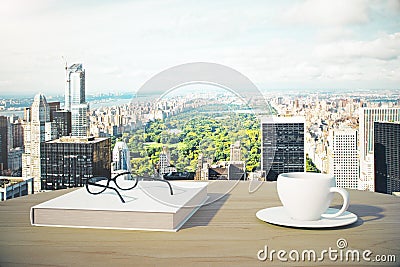Great city view with cup of coffee, book and glasses Stock Photo