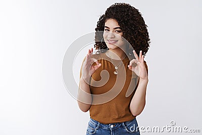 Great deal trust me. Good-looking satisfied confident european female customer curly dark hair satisfied awesome haircut Stock Photo