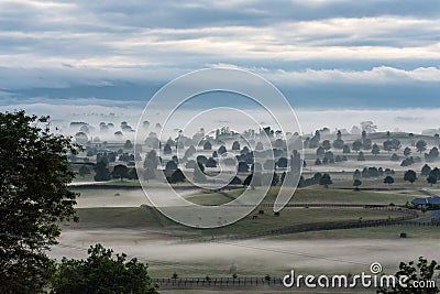 Great foggy pasture landscape in the early morning in Matamata, the true Hobbiton landscape, New Zealand Stock Photo