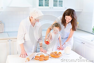 Great grandmother baking apple pie with her family Stock Photo