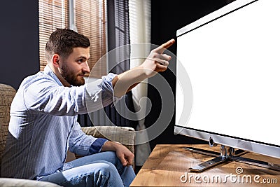 Great idea. Delighted freelancer raising his forefinger out and wrinkling forehead while having plan. Watching with Stock Photo