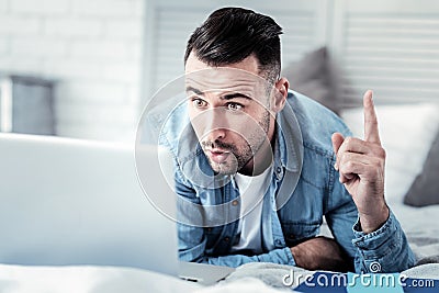 Surprised brunette looking at his laptop Stock Photo