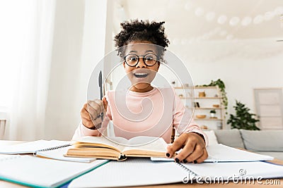 Excited Teen Girl Having Eureka Moment Doing Homework At Home Stock Photo