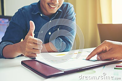 Great job!.Employee in the office after review document and encourages for done excellent work. Stock Photo