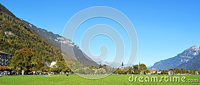 Interlaken, Switzerland, Mountains, houses and huge lawn yard field Stock Photo