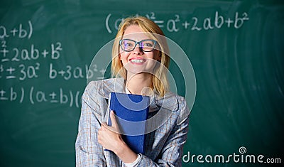 Great letter of recommendation. Woman smiling teacher hold book stand front chalkboard. Recommendation for college Stock Photo