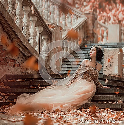 Great-looking charming dark-haired brunette girl sitting alone on the stone steps of an amazing royal castle, pretty Stock Photo