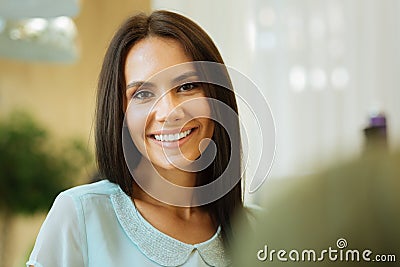 Pleasant cheerful woman looking at you Stock Photo