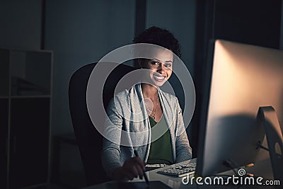 Great results require a dedicated amount of hours. Portrait of a young businesswoman working late on a computer in an Stock Photo