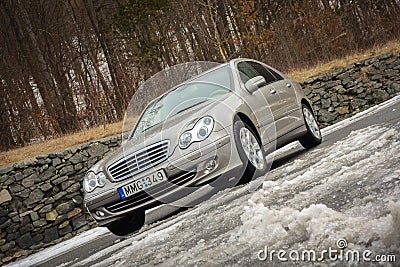 Cluj-Napoca,Romania - March 01,2018:Isolated Mercedes-Benz E class-alias W203,gold metallic colour,chrome ornaments blue tinted Editorial Stock Photo