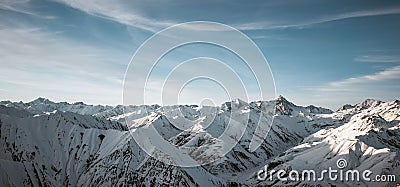 Great view of the massive snowy mountains. Amazing winter rocks above the cloud Stock Photo