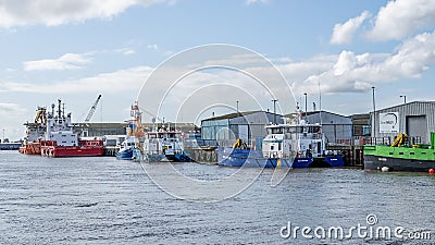 Commercial ships and boats unloading cargo in the seaside town of Great Yarmouth Editorial Stock Photo