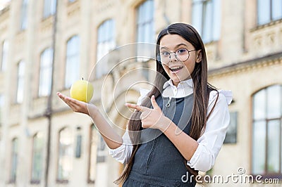 Great for your teeth. Little kid point finger at apple. School snack. Healthy eating. Dental health. Oral examination Stock Photo