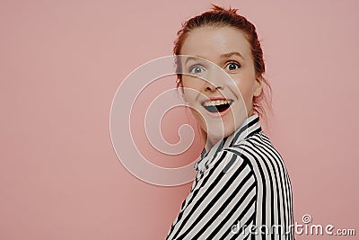 Greatly surpirsed brunette teen girl in striped shirt Stock Photo