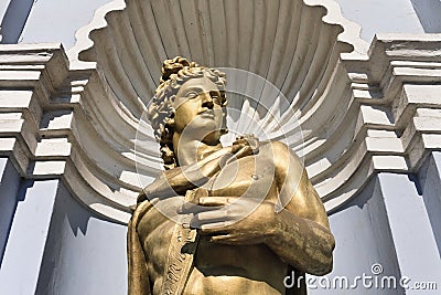 Greece ancient male god, in front of a colonial building Stock Photo