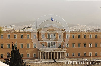 Greece, Athens pollution. Unhealthy grey smog over parliament at Syntagma. Sky, hill and town background. Stock Photo