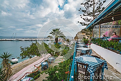 Greece Crete. Restaurant with served table in seafront of sea view island with breathtaking, amazing and unbelievable Editorial Stock Photo