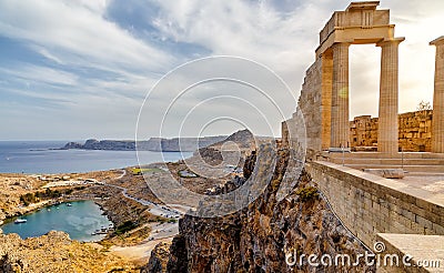 Greece. Rhodes. Acropolis of Lindos. Doric columns of ancient Temple of Athena Lindia the IV century BC and the bay of Stock Photo