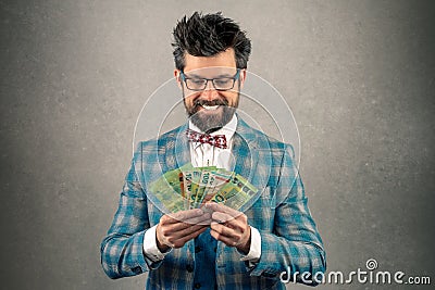 Greedy businessman looking the money in his hand Stock Photo