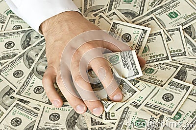 Greedy hand grabs money Stock Photo