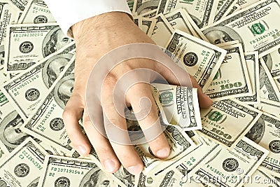 Greedy hand grabs money Stock Photo
