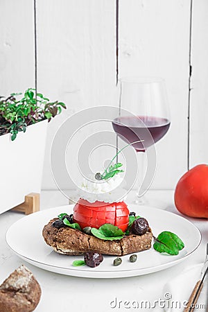 Barley rusk called dakos ,topped with feta cheese, tomato cubes,olive oil and oregano ,typical Greek plate served with Stock Photo