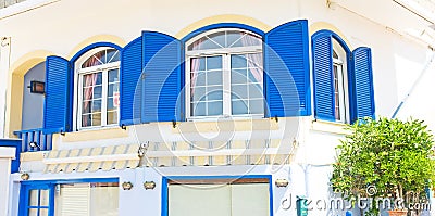 Greek blue windows and shutters. Stock Photo