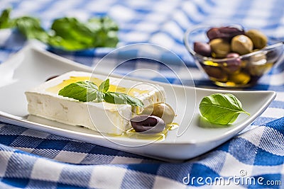 Greek cheese feta with olive oil olives and basil leaves Stock Photo