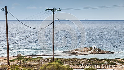 Greek coastline, Agios Fokas chapel and power line Stock Photo