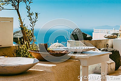 Greek corner shop of vases in front of the sea and sky Stock Photo