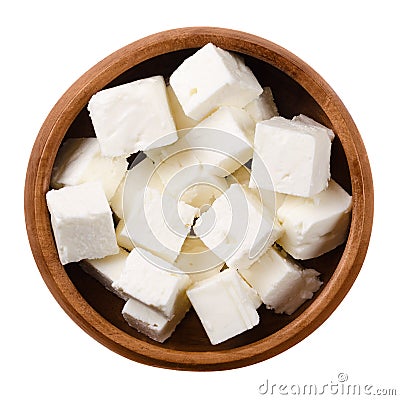 Greek Feta cheese cubes in wooden bowl over white Stock Photo