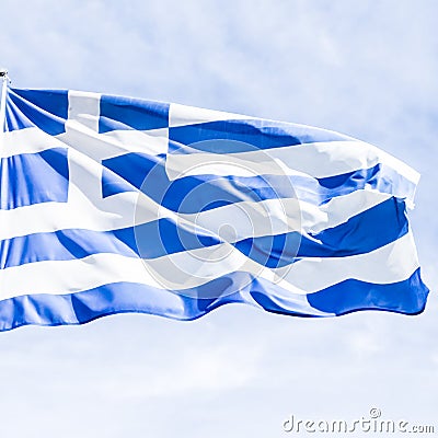 Greek flag and cloudy sky in summer day, politics of Europe Stock Photo