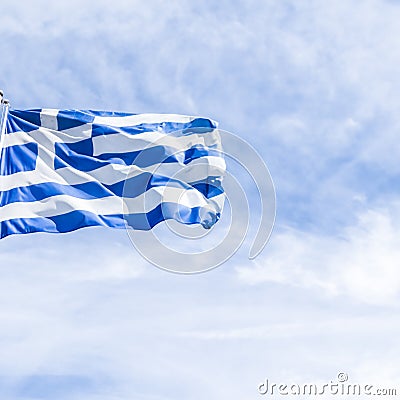 Greek flag and cloudy sky in summer day, politics of Europe Stock Photo